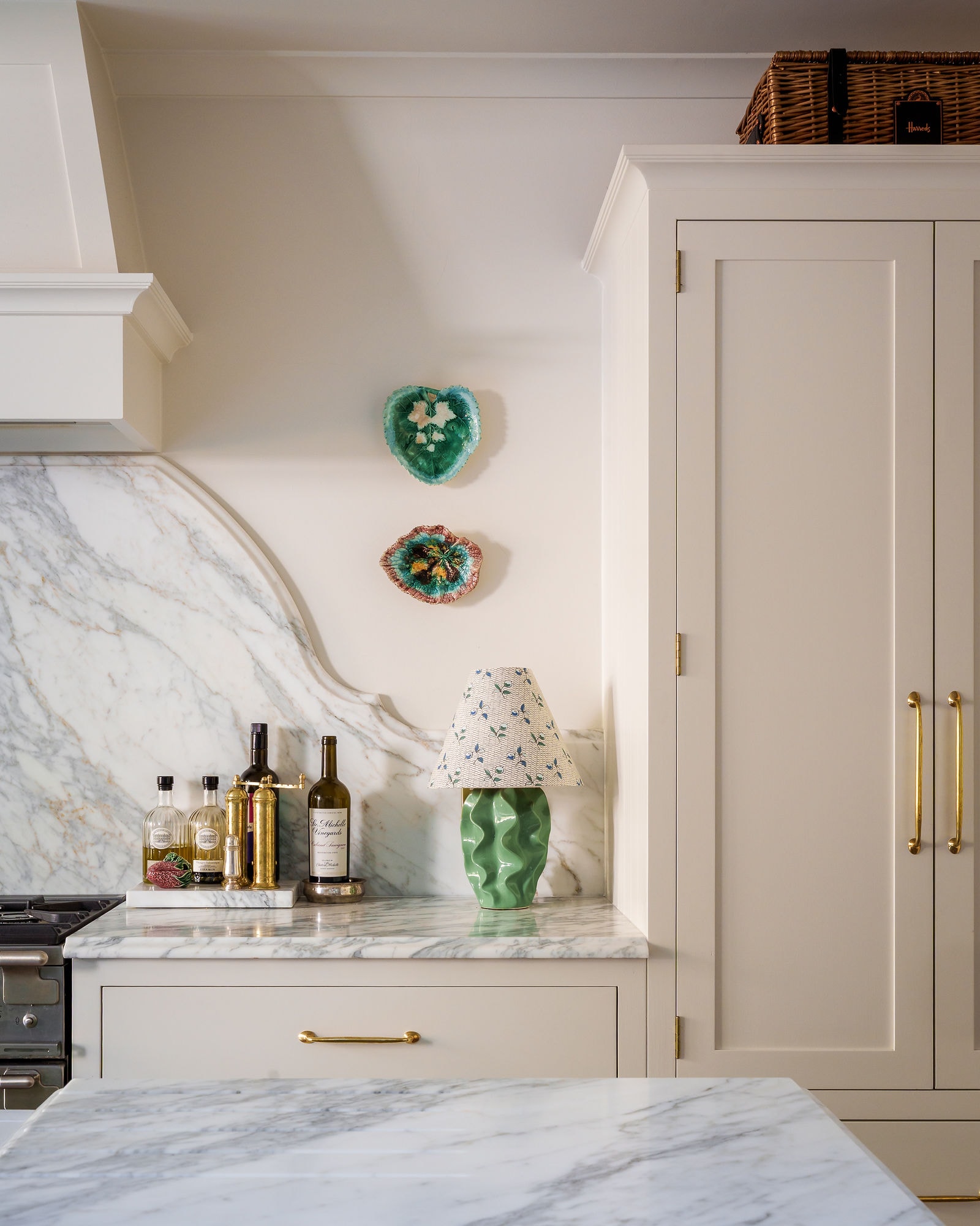 Modern kitchen with marble countertop and green island